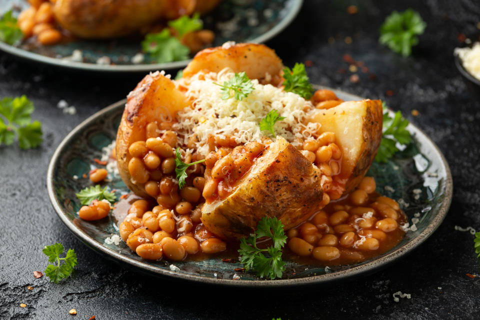 Baked potato with tomato beans and cheddar cheese. Traditional British food.