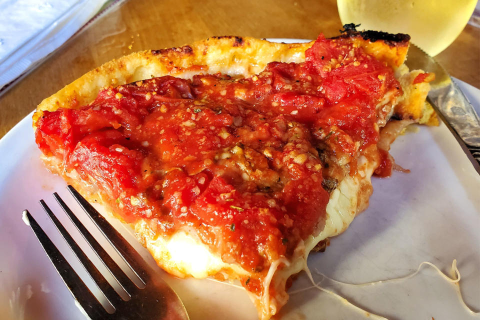 A slice of deep dish pizza.