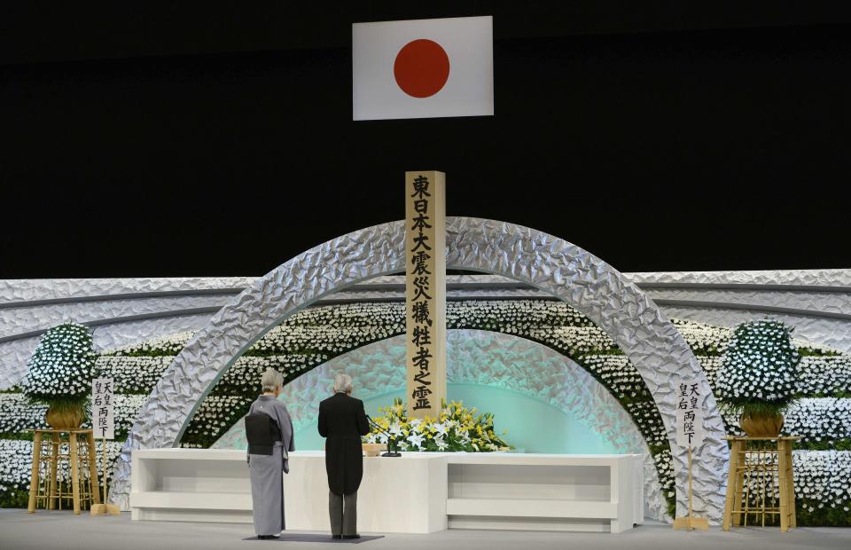 Japan's Emperor Akihito (R) and Empress Michiko delivers an address in front of the altar for the victims of the March 11, 2011 earthquake and tsunami at the national memorial service in Tokyo March 11, 2014. (REUTERS/Franck Robichon/Pool)