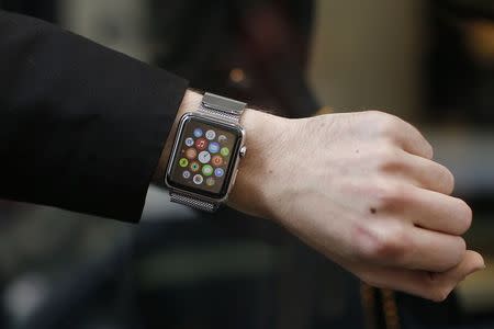 A customer presents his Apple Watch after buying it at a store in Paris, France, April 24, 2015. REUTERS/Benoit Tessier