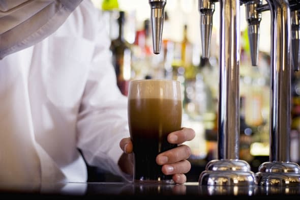 Barman pulling a pint of stout