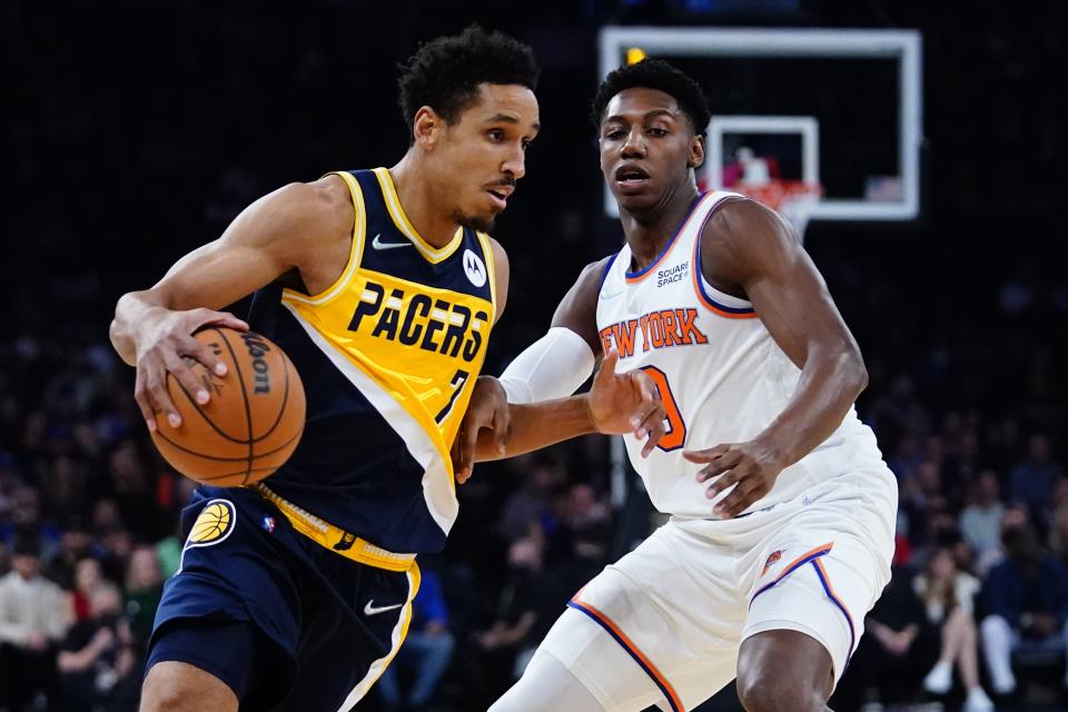 Indiana Pacers' Malcolm Brogdon (7) drives past New York Knicks' RJ Barrett (9) during the first half of an NBA basketball game Monday, Nov. 15, 2021, in New York. (AP Photo/Frank Franklin II)
