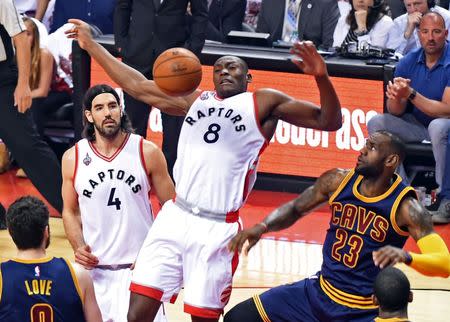 May 23, 2016; Toronto, Ontario, CAN; Toronto Raptors center Bismack Biyombo (8) goes up for a rebound above forward Luis Scola (4) and Cleveland Cavaliers forward LeBron James (23) in game four of the Eastern conference finals of the NBA Playoffs at Air Canada Centre. Mandatory Credit: Dan Hamilton-USA TODAY Sports