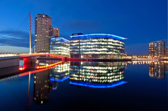 BBC Media City at Salford Quays and reflected in Manchester ship canal.
