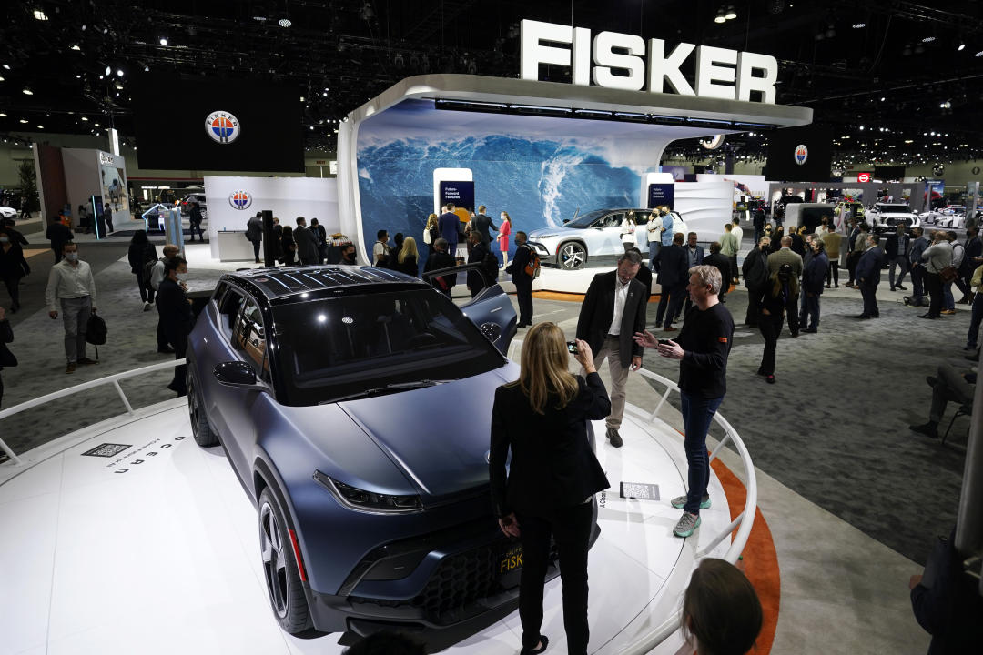 FILE - Henrik Fisker, Chairman & CEO at Fisker Inc. at right, shows his company's new EV, the Ocean, at the AutoMobility LA Auto Show Nov. 17, 2021, in Los Angeles. Fisker filed for Chapter 11 bankruptcy protection, Monday, June 17, 2024, the second electric startup to do so in the last year as even industry leaders struggle to lure more buyers beyond the early adapters of the technology. (AP Photo/Marcio Jose Sanchez, File)