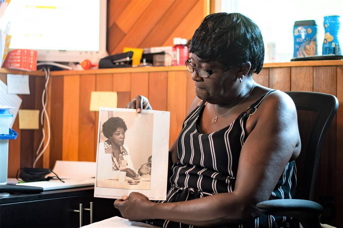 Symetta Williams, 62, hold a copy of a portrait of her late mother, Joyce Nichols, in her home on July 15, 2022, a day after the Durham Housing Authority named a new development after Nichols.