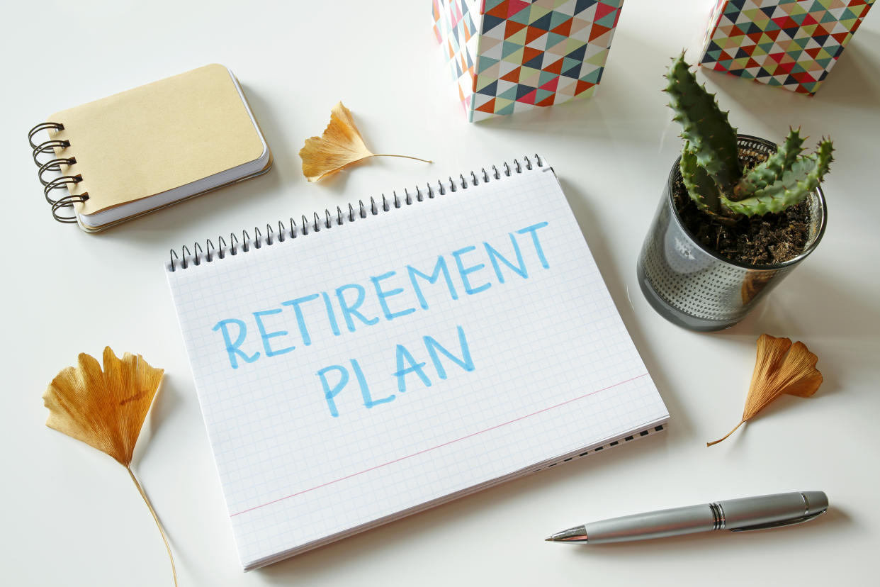 retirement plan written in notebook on white table