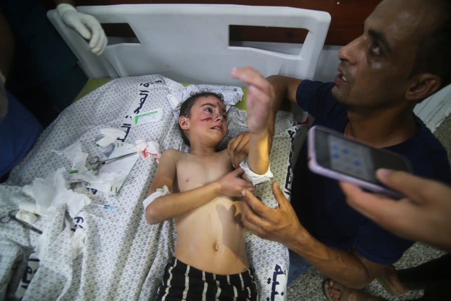 A Palestinian child wounded in Israeli bombardment waits for treatment in a hospital in Rafah refugee camp, southern Gaza Strip, Thursday, Oct. 12, 2023. (AP Photo/Hatem Ali)