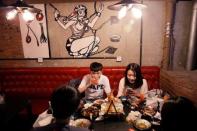 Customers eat a meal at Ke'er restaurant (Shell in English) in Beijing, China, May 26, 2016. REUTERS/Kim Kyung-Hoon