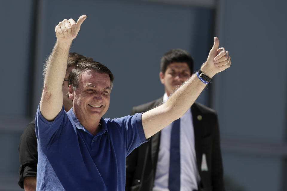 Brazil's President Jair Bolsonaro signals thumbs up to his supporters during a protest against his former Minister of Justice Sergio Moro and the Supreme Court, in front of the Planalto presidential palace, in Brasilia, Brazil, Sunday, May 3, 2020. (AP Photo/Eraldo Peres)