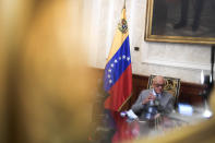 Reflected in a mirror, National Assembly President Jorge Rodriguez gives an interview at Congress in Caracas, Venezuela, Friday, Jan. 15, 2021. Rodriguez said he’s hopeful the Biden administration will roll back a “cruel” sanctions policy and instead give room for diplomacy that could lead to the reopening of the U.S. Embassy and the release of several jailed American citizens. (AP Photo/Matias Delacroix)