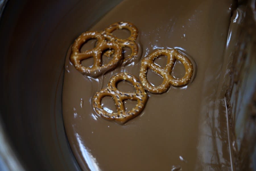 NORTH MIAMI, FL – FEBRUARY 12: Pretzels are covered with chocolate as they are prepared to be sprinkled with little candy hearts as the Le Chocolatier fine chocolate store prepares for a Valentine’s Day rush on February 12, 2014, in North Miami, Florida. Chocolate is one of the most popular gift-giving traditions during Valentine’s Day. (Photo by Joe Raedle/Getty Images)