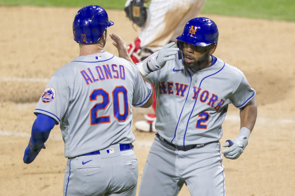 New York Mets Dominic Smith (2) celebrates with Pete Alonso (20) after hitting a two run homer during the fourth inning of a baseball game against the Philadelphia Phillies, Tuesday, April 6, 2021, in Philadelphia. (AP Photo/Laurence Kesterson)