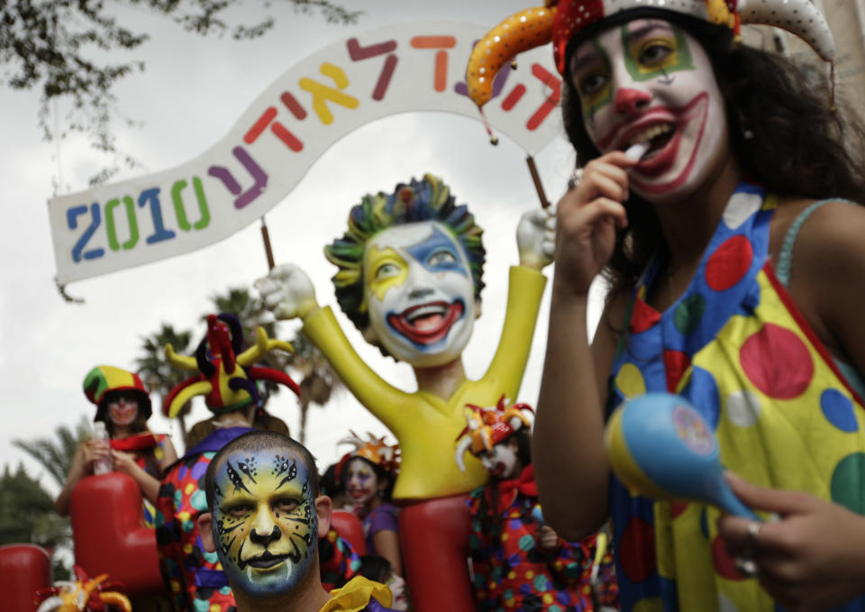 Israelis in costumes and masks dance in the street during the annual Purim parade in Holon, near Tel Aviv, Israel, Monday, March 1, 2010. (AP Photo/Ariel Schalit)