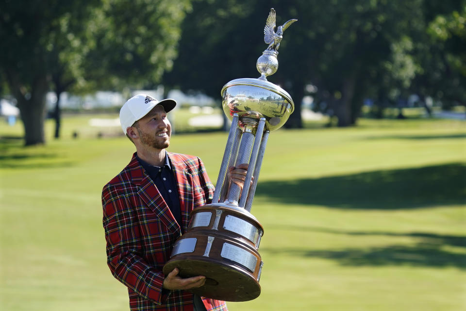 Daniel Berger poses with the trophy after winning the Charles Schwab Challenge in a playoff at Colonial Country Club in Fort Worth, Texas. (AP Photo/David J. Phillip)