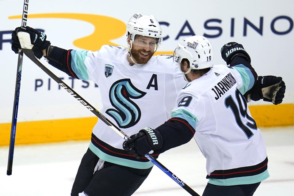 Seattle Kraken's Adam Larsson (6) celebrates with Calle Jarnkrok after scoring the game-winning goal in the overtime period of an NHL hockey game against the Pittsburgh Penguins in Pittsburgh, Thursday, Jan. 27, 2022. The Kraken won in overtime 2-1. (AP Photo/Gene J. Puskar)