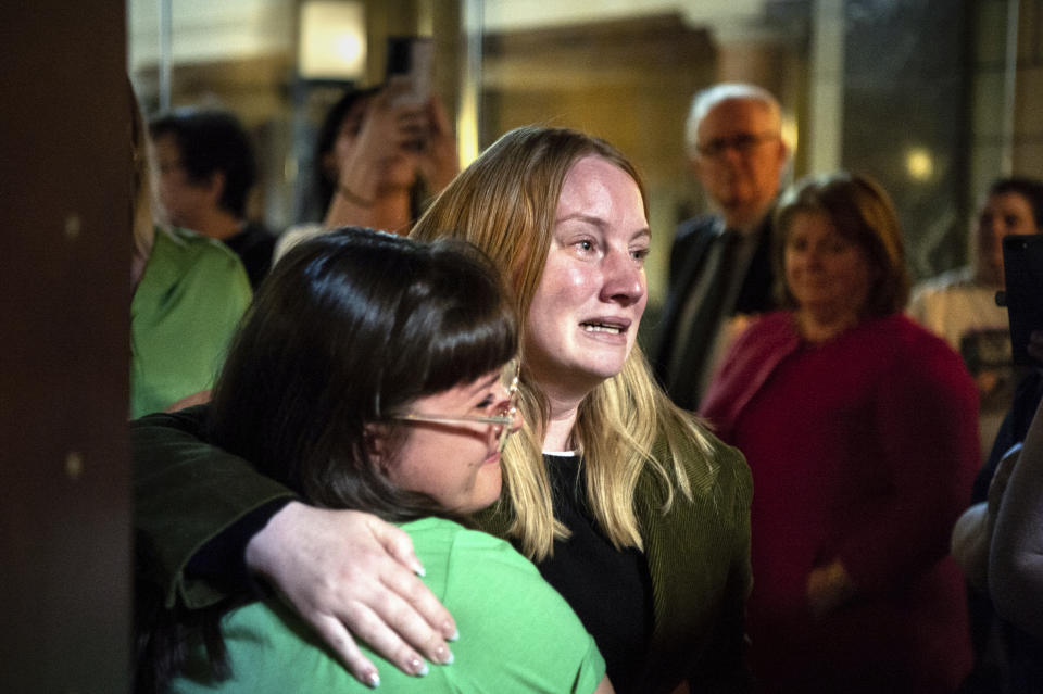 FILE - State Sen. Megan Hunt, right, hugs a supporter, April 27, 2023, at the Nebraska State Capital in Lincoln, Neb. Conservative Nebraska lawmakers are taking what could be an all-or-nothing bet by proposing to merge two of the session's most contentious proposals — one to restrict abortion access and another that would ban gender-affirming care for transgender minors. The strategy sets up a vote on Tuesday, May 16, 2023 that could give conservatives a win on both abortion and trans health bans this year — or could see them lose both. (Larry Robinson/Lincoln Journal Star via AP, file)