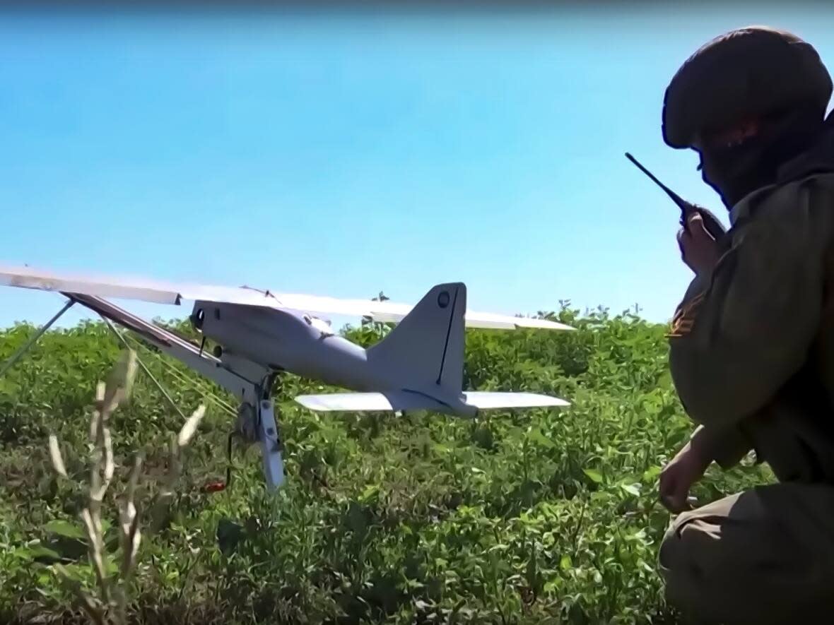 A Russian soldier prepares an Orlan-10 drone for launch. Russia's ambassador to Canada says it's possible for some of these drones to be made with Western components. (Russian Defense Ministry Press Service/AP - image credit)