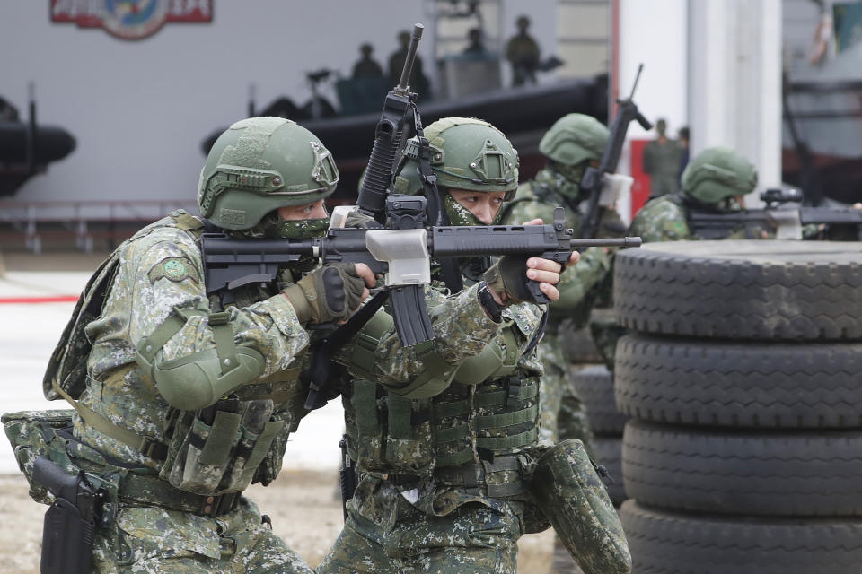 Soldiers perform moving shooting as Taiwan President Tsai Ing-wen inspects at the Penghu Magong military base in outlying Penghu Island, Taiwan, Friday, Dec. 30, 2022. (AP Photo/ Chiang Ying-ying)