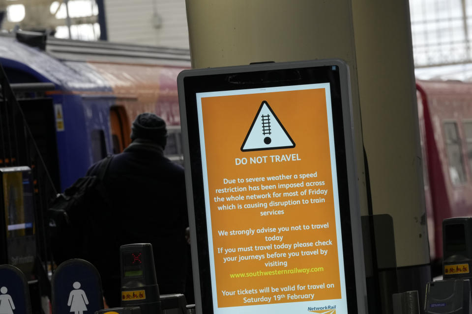 Signs showing cancellations across the board as commuters look at options as all trains from Waterloo Station are cancelled due to sever weather n London, Friday, Feb. 18, 2022. Millions of Britons are being urged to cancel travel plans and stay indoors Friday amid fears of high winds and flying debris as the second major storm this week prompted a rare "red" weather warning across southern England (AP Photo/Alastair Grant)