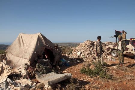 Members of the Libyan pro-government forces, stand near their tent during their deployment in the Lamluda area, southwest of the city of Derna, Libya June 16, 2015. Picture taken June 16, 2015. REUTERS/Stringer