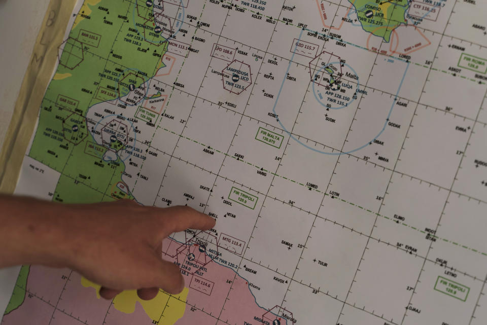 Felix Weiss, who heads Sea-Watch's airborne operations points to a map of the Mediterranean Sea during an interview in Lampedusa, Italy, Tuesday, Oct. 5, 2021. Sea-Watch is tasked with documenting human rights violations committed against migrants at sea and relaying distress cases to nearby ships and authorities who have increasingly ignored their pleas. (AP Photo/Renata Brito)