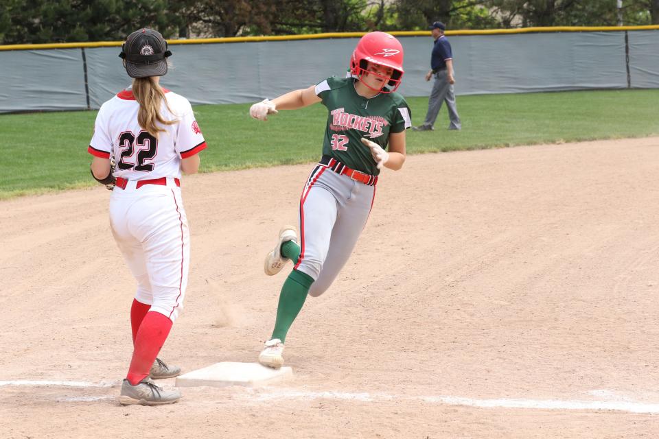 Oak Harbor's Alyse Sorg rounds third and looks to score.