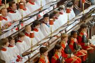 Members of the choir await the arrival of Queen Elizabeth II during the service to celebrate the 60th anniversary of the Coronation of the Queen at Westminster Abbey, London.