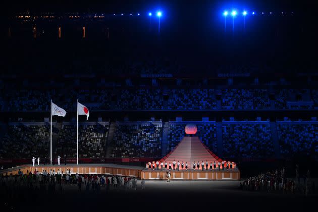 The Olympic and Japanese flags sway in the wind.  (Photo: DYLAN MARTINEZ via Getty Images)