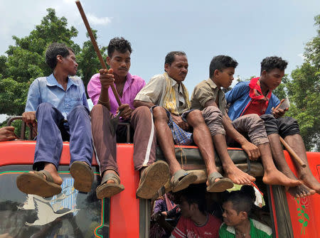 Members of the Dongria Kondh tribe arrive to attend a protest rally demanding the ouster of a Vedanta Limited alumina plant in Lanjigarh in the eastern state of Odisha, India, June 5, 2018. REUTERS/Krishna N. Das