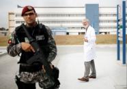 Francisco Radler, director of the Brazilian Laboratory for Doping Control, enters inside the Laboratory as a Brazilian army soldier patrols after an interview with Reuters in Rio de Janeiro, Brazil, July 29, 2016. REUTERS/Nacho Doce