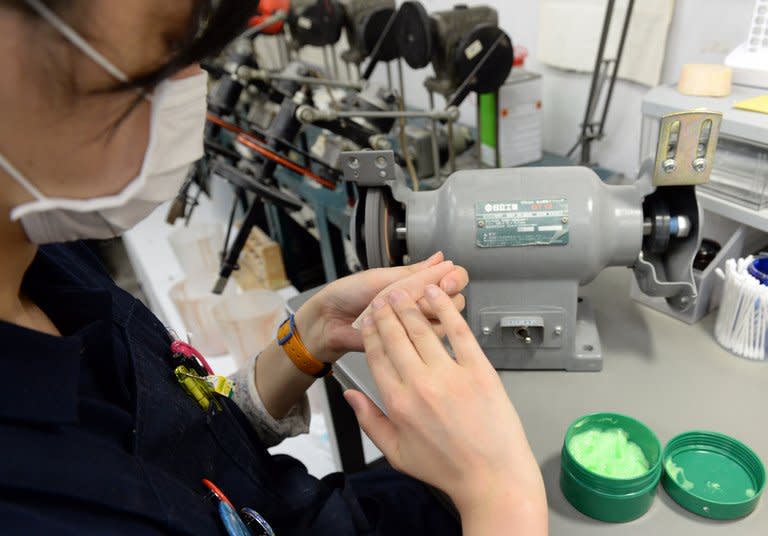 A prosthetics technician prepares a silicone-made finger at specialist Shintaro Hayashi's office in Tokyo, on May 27, 2013. Going straight after a lifetime spent as a member of Japan's feared yakuza organised crime mobs poses a number of challenges. Chief among them is what to do about the fingers you chopped off