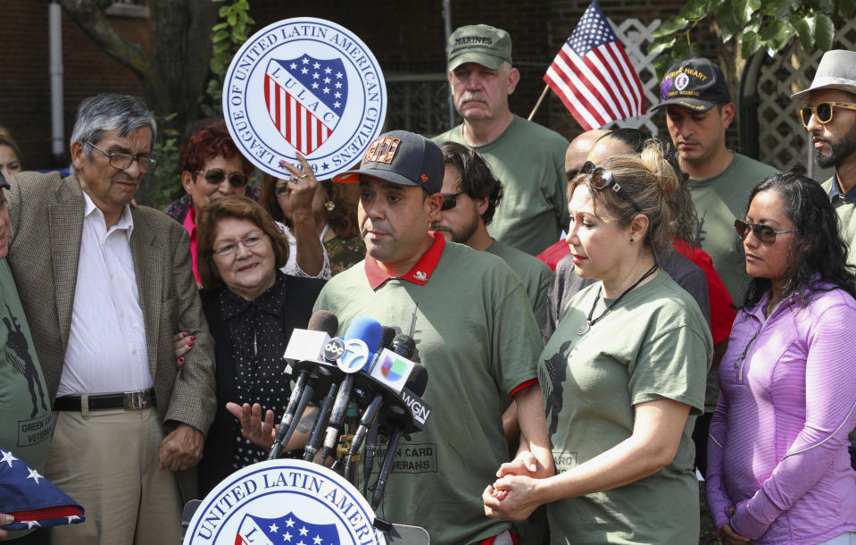 Miguel Perez Jr., center, is surrounded by family and supporters at a news conference in Chicago on Tuesday, Sept. 24, 2019. Perez, an Army veteran who was deported to Mexico in 2018 arrived back in Chicago Tuesday for a final chance at becoming a U.S. citizen and living in the city he has called home since boyhood. (AP Photo/Teresa Crawford)