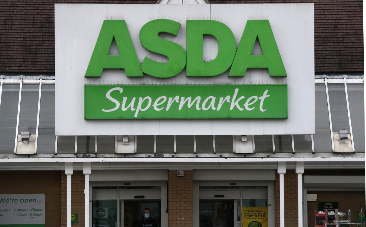 The entrance of an ASDA supermarket in London, Friday, March 26, 2021. More than 40,000 store workers at Asda, Britain's third-largest supermarket chain, can proceed with their longstanding claim for equal pay following a ruling from the country's Supreme Court. The workers, around two-thirds of whom are women, first brought their sex discrimination claim in 2014. (AP Photo/Frank Augstein)