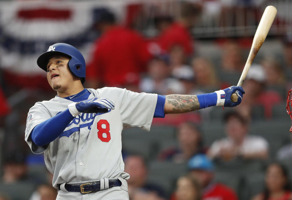 Los Angeles Dodgers shortstop Manny Machado (8) watches his three-run homer against the Atlanta Braves during the seventh inning in Game 4 of baseball's National League Division Series, Monday, Oct. 8, 2018, in Atlanta. (AP Photo/John Bazemore)