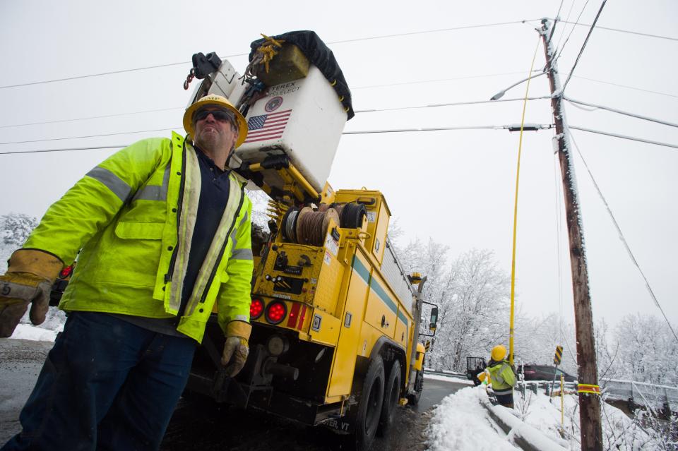 After working through much of the night, Green Mountain Power linemen Garth Lizotte and Jacob Rieder were able to take a break after restoring power to Gentes Road in Essex, Vermont, on Nov. 28, 2018. Heavy, wet snow weighed down tree limbs and power lines, cutting power across Vermont.