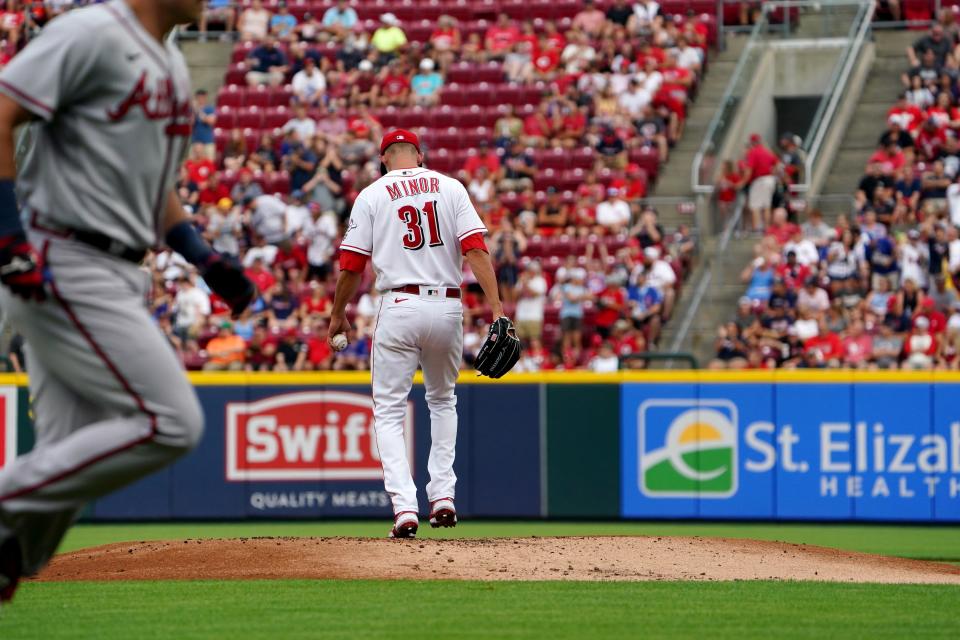 Cincinnati Reds starting pitcher Mike Minor (31) kicks the dirt on the mound as Atlanta Braves third baseman Austin Riley (27) rounds the bases after hitting a two-run home run during the first inning of a baseball game, Friday, July 1, 2022, at Great American Ball Park in Cincinnati.