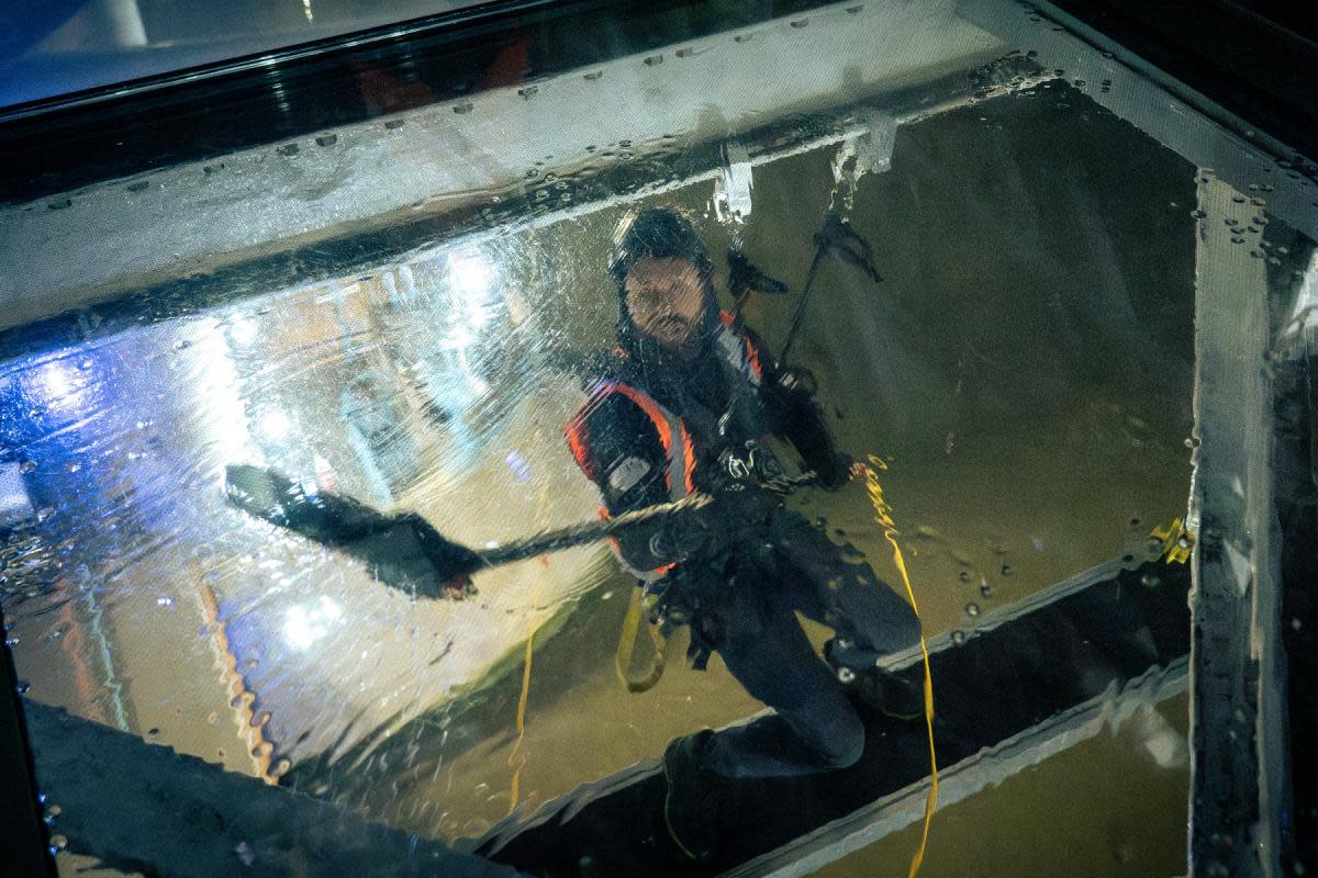 High up - workers from LDT Contractors cleaning Tower Bridge’s glass floors <i>(Image: City Bridge Foundation)</i>