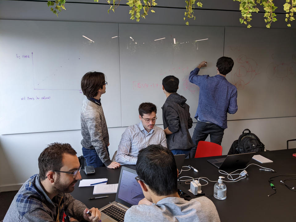 Sevilla, bottom left, alongside members of the founding team in a meeting room at Epoch's first retreat in April 2022. During this event the members decided to constitute an organization and chose the name Epoch with the assistance of a Twitter poll. <span class="copyright">Courtesy Sevilla/Jennifer Waldmann</span>