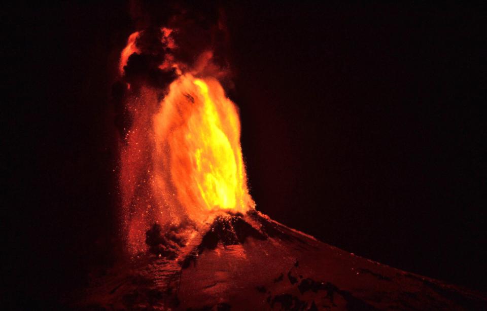 Ash and lava spew from the Villarrica volcano, as seen from Pucon town in the south of Santiago