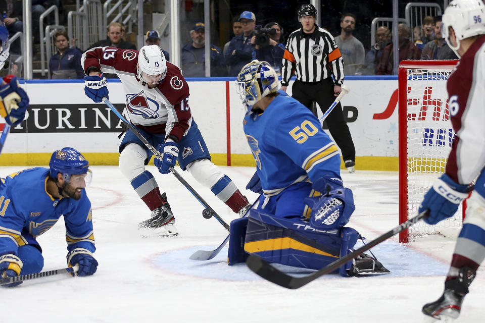 Colorado Avalanche's Valeri Nichushkin (13) prepares to score a goal past St. Louis Blues goaltender Jordan Binnington (50) during the third period of an NHL hockey game Saturday, Feb. 18, 2023, in St. Louis. (AP Photo/Scott Kane)