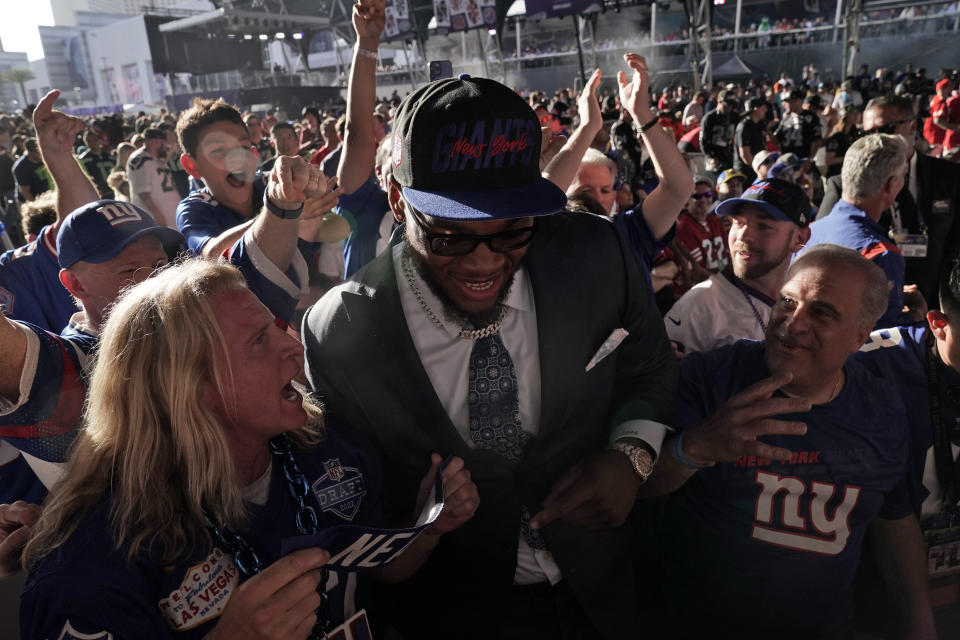 Alabama offensive tackle Evan Neal celebrates with fans after being picked by the New York Giants with the seventh pick of the NFL football draft Thursday, April 28, 2022, in Las Vegas. (AP Photo/Jae C. Hong)