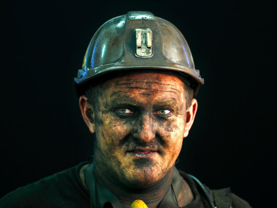 Coal miner Miroslaw Blasiak, a combine operator, poses for a photograph following his shift at Zofiowka coal mine of the JSW coal mine company, in Jastrzebie Zdroj, southern Poland September 27, 2012. State-controlled JSW, the biggest coking coal producer in the European Union, risks making an unexpected net loss in the third quarter and remaining in the red for the full year due to slumping coal prices, its chief executive said August 1, 2013. The company had undertaken several steps to counter the fall in prices, aiming to lower costs by up to 200 million zlotys ($62 million) by the end of this year. JSW has cut capital investment and plans to cut labour costs further. The management board is negotiating with unions to freeze wages for a year and wants cut some employee benefits. TO GO WITH STORY POLAND-JSW/ Photo taken September 27, 2012.
