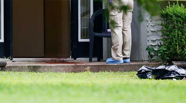 A quantity of blood can be seen on the doorstep of the house. Photo: AP