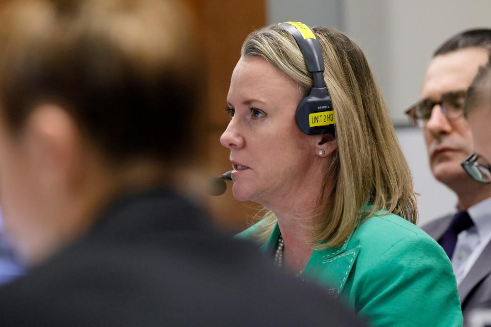 Assistant Public Defender Melisa McNeill participates in a sidebar discussion via headset during the penalty phase of the trial of Marjory Stoneman Douglas High School shooter Nikolas Cruz at the Broward County Courthouse in Fort Lauderdale on Monday, Oct. 3, 2022. Cruz previously plead guilty to all 17 counts of premeditated murder and 17 counts of attempted murder in the 2018 shootings. (Amy Beth Bennett/South Florida Sun Sentinel via AP, Pool)