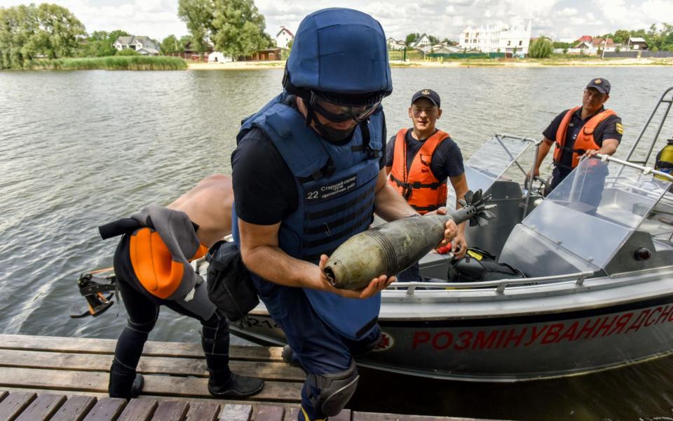 State Emergency Service of Ukraine shows members of a demining team working to clear an area at the lake in Hostomel town near Kyiv (Kiev), Ukraine, 27 June 2022. - OLEG PETRASYUK/EPA-EFE/Shutterstock