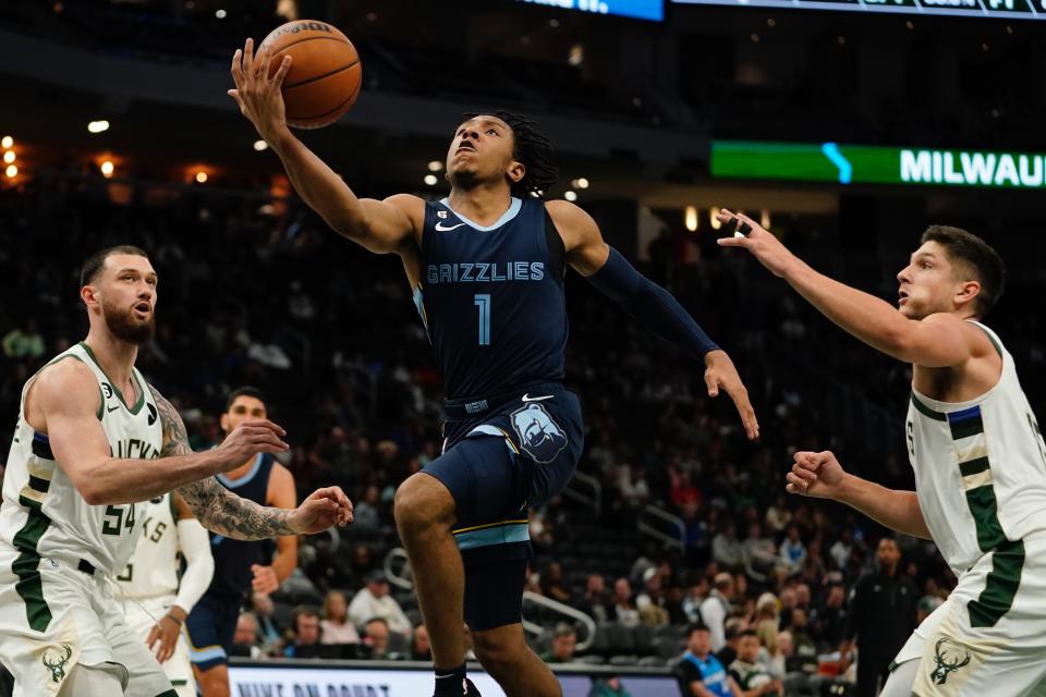 Memphis Grizzlies' Kennedy Chandler shoots between Milwaukee Bucks' Grayson Allen snd Sandro Mamukelashvili during the second half of an NBA preseason basketball game Saturday, Oct. 1, 2022, in Milwaukee. (AP Photo/Morry Gash)