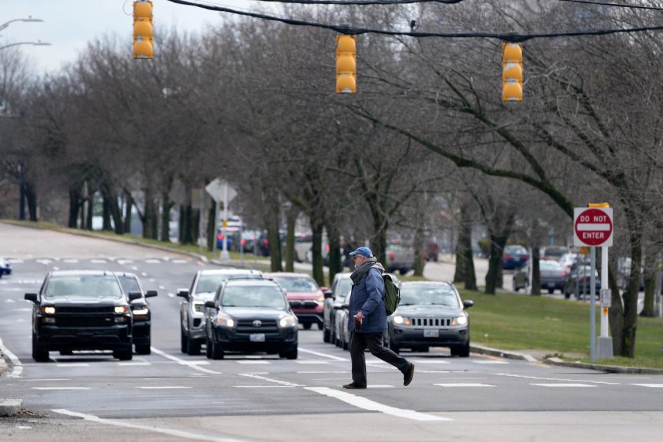 A pedestrian crosses a multi-lane intersection on North Main Street in Providence on Tuesday.