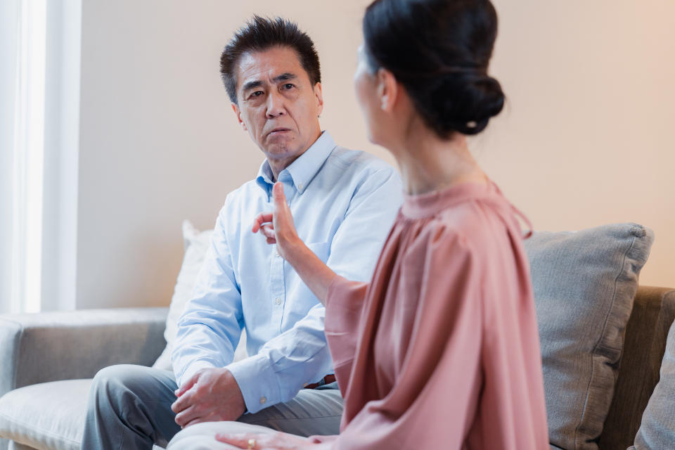 Man and woman on a couch arguing