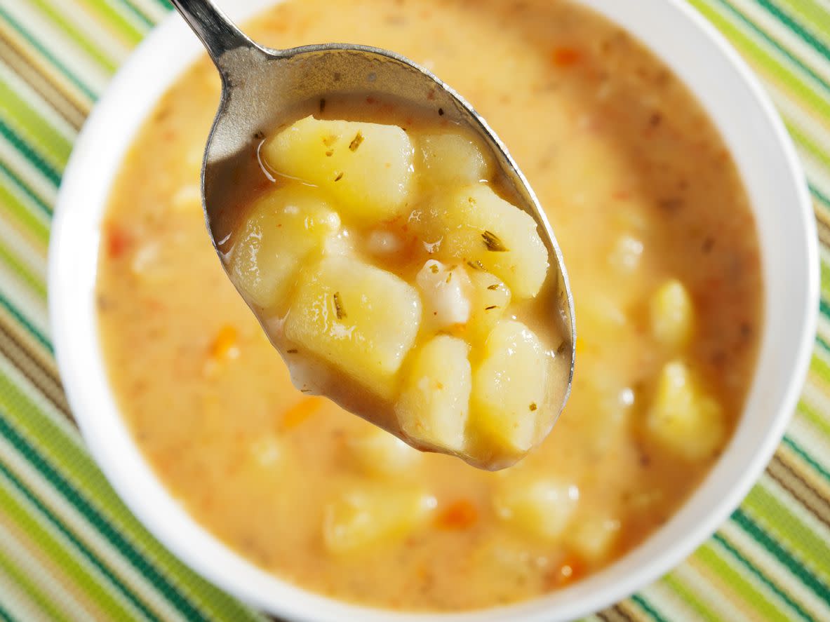 Spoonful of potato soup close up